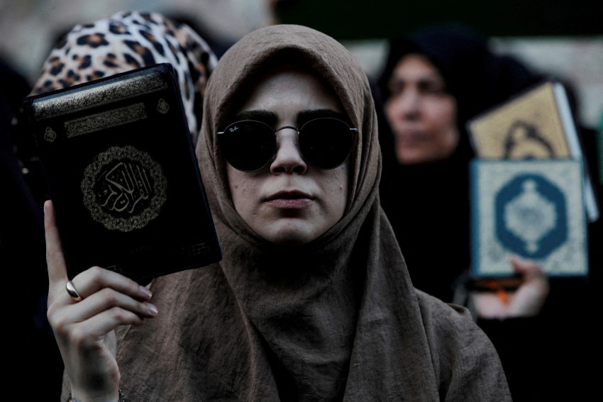 FILE PHOTO: FILE PHOTO: Protesters hold copies of the Koran as they demonstrate outside the Consulate General of Sweden in Istanbul